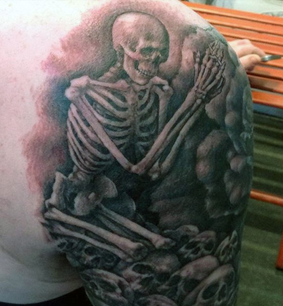 Impressive designed big black and white praying skeleton tattoo on shoulder