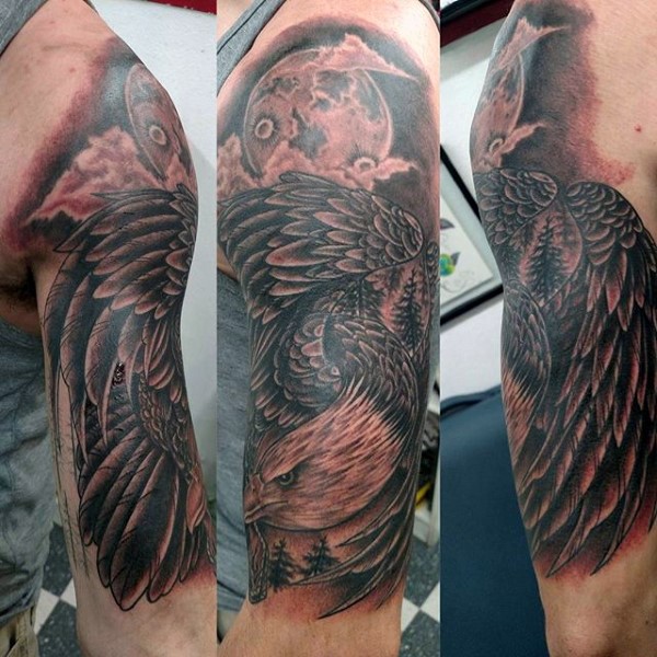 Impressive designed black ink flying eagle with moon tattoo on arm