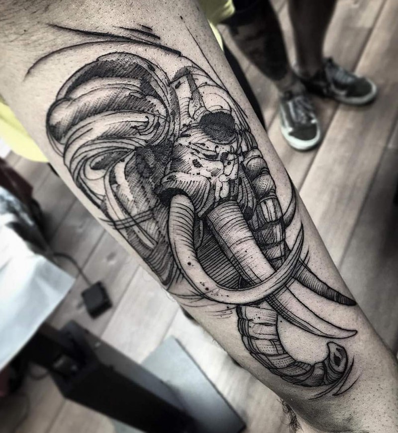 Impressive detailed black ink forearm tattoo of old tribal elephant head