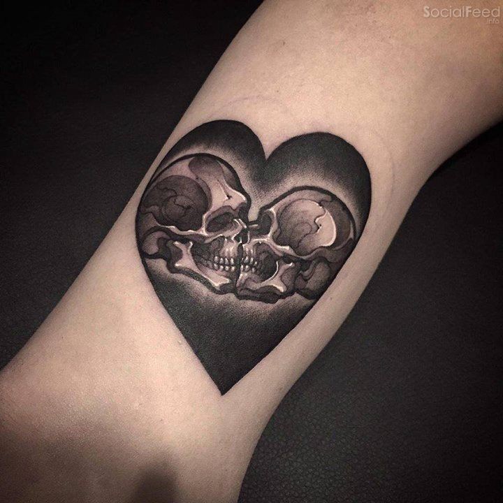 Impressive heart shaped tattoo stylized with kissing skeleton couple