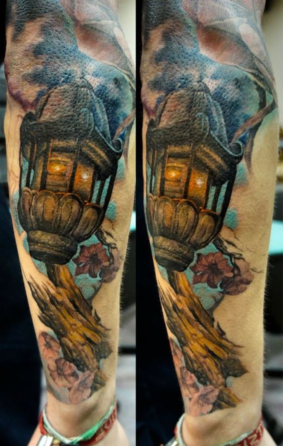Impressive looking arm tattoo of vintage city lighter with tree branch
