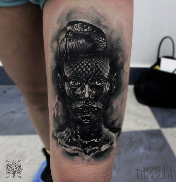 Impressive looking black ink thigh tattoo of dark woman with snake