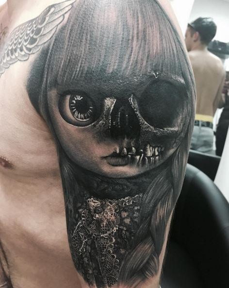 Impressive looking very detailed shoulder tattoo of half normal half skeleton doll