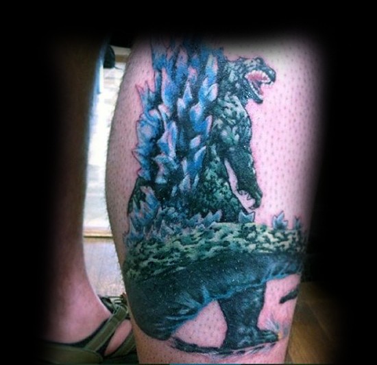 Impressive painted big colored Godzilla tattoo on leg