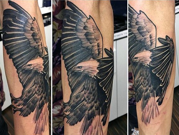 Impressive painted big realistic detailed eagle tattoo on arm