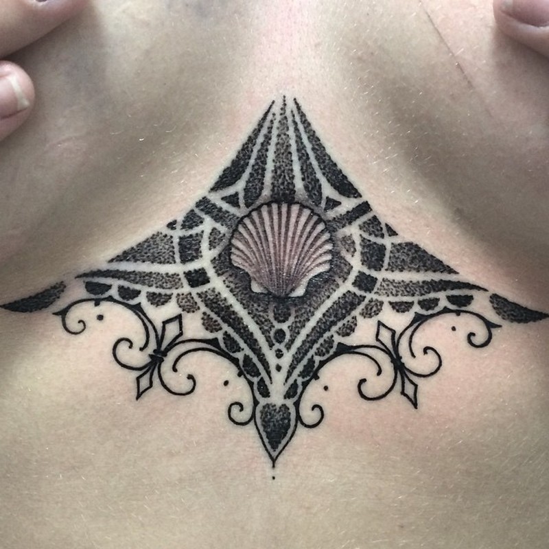 Impressive painted black ink shell with ornaments tattoo on chest