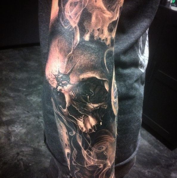 Impressive very detailed arm tattoo of human skull with hole