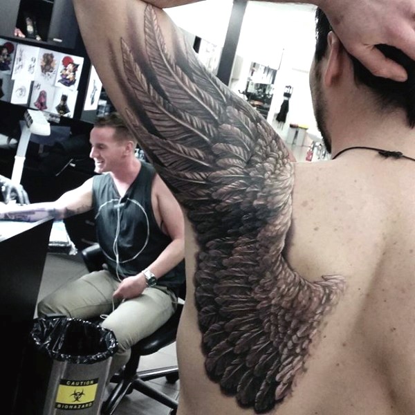 Impressive very detailed black and white wing tattoo on shoulder