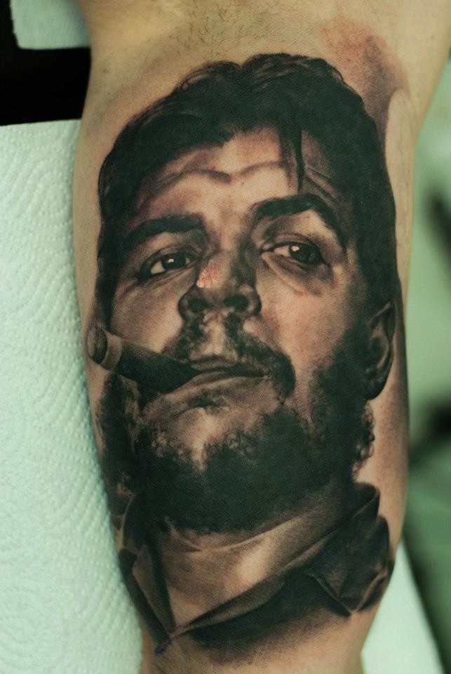 Impressive very detailed natural looking smoking man portrait tattoo on biceps