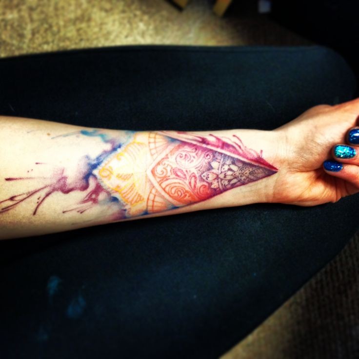 Impressive watercolor style painted mystical figure tattoo on wrist