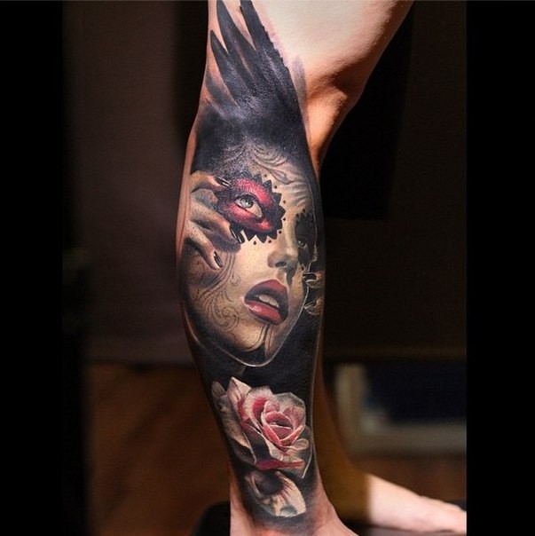 Incredible big black ink crow wing tattoo on leg stylized with Mexican traditional woman portrait and flowers