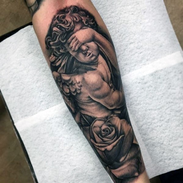 Incredible black and white little angel tattoo on forearm with rose