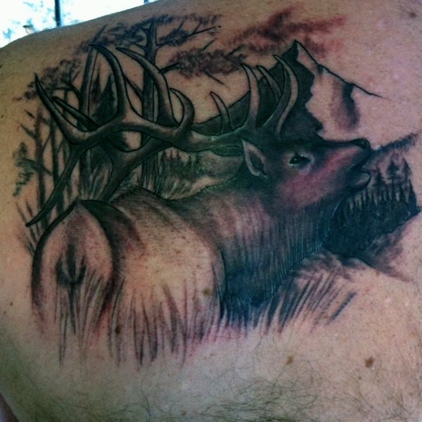 Incredible black and white shoulder tattoo of detailed deer in forest