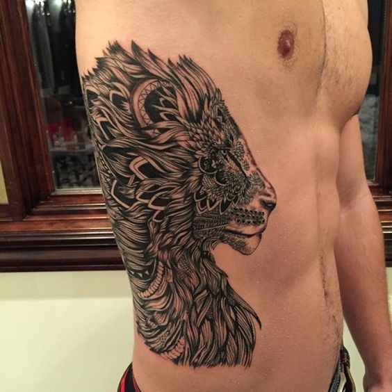 Incredible black and white very detailed lion tattoo on side stylized with various ornaments