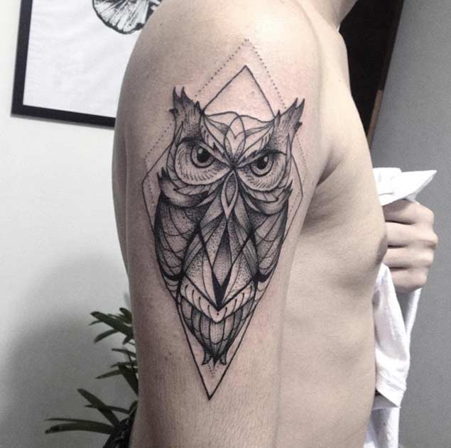 Incredible black ink colored strange owl tattoo with geometrical figure
