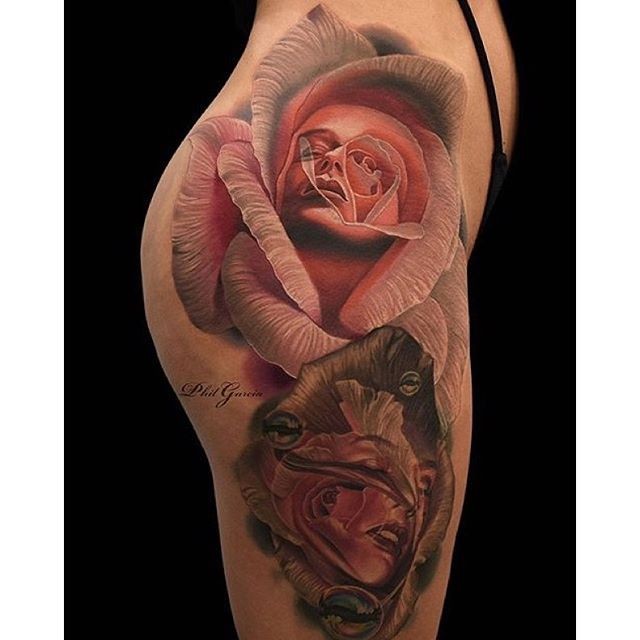 Incredible colored thigh tattoo of roses stylized with woman faces