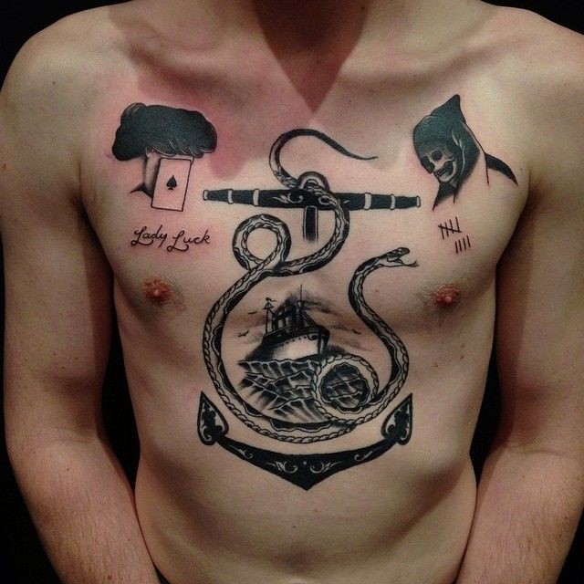 Incredible combined black ink chest tattoo of anchor with snake and lettering