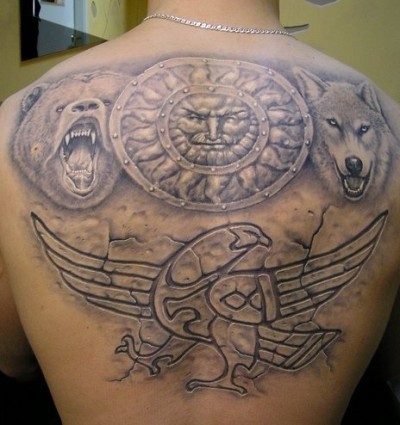Incredible designed very detailed various animals tattoo on upper back stylized with tribal ornaments