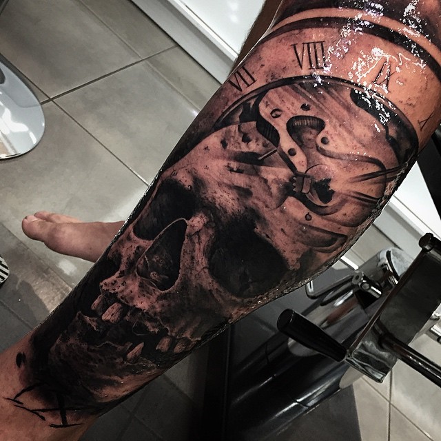 Incredible detailed black and white skull tattoo on leg with old clock