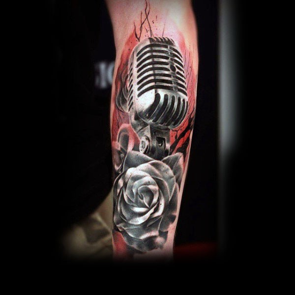 Incredible detailed colored vintage microphone with flowers tattoo on arm