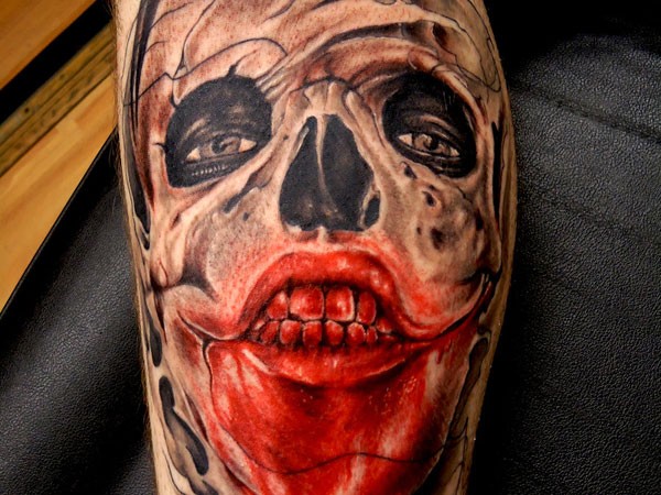 Incredible looking colored arm tattoo of bloody skull