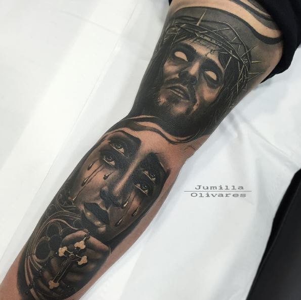 Incredible looking colored arm tattoo of demonic Jesus face with crying woman with cross
