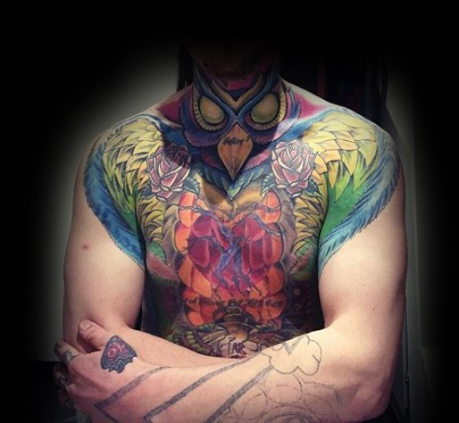 Incredible looking colored chest and shoulder tattoo of mystical bird and flowers