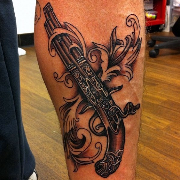 Incredible looking colored forearm tattoo of antic pistol