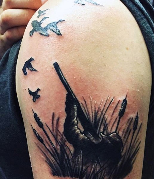 Incredible looking realism style hunter and flying ducks tattoo on shoulder