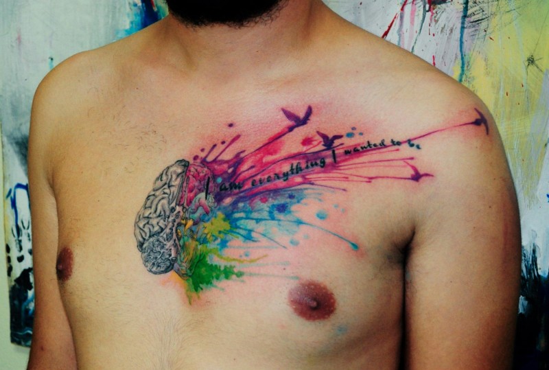 Incredible multicolored brain with lettering tattoo on chest stylized with flying birds