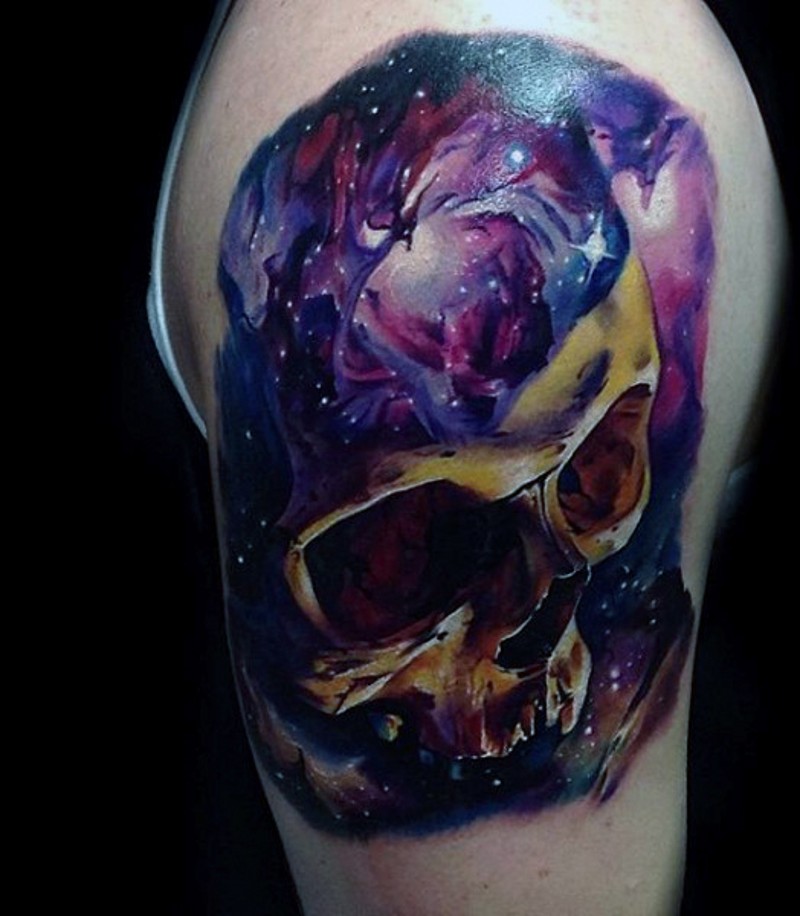 Incredible painted and colored big skull stylized with space tattoo on upper arm