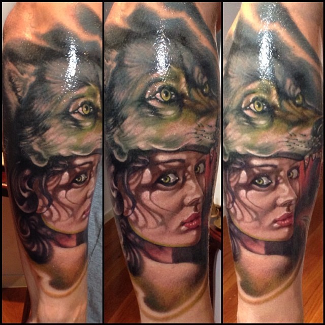 Incredible realism style colorful forearm tattoo of woman portrait with helmet made from wolf skin