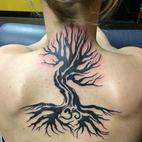 Incredible tribal style black ink big tree tattoo on upper back with symbol