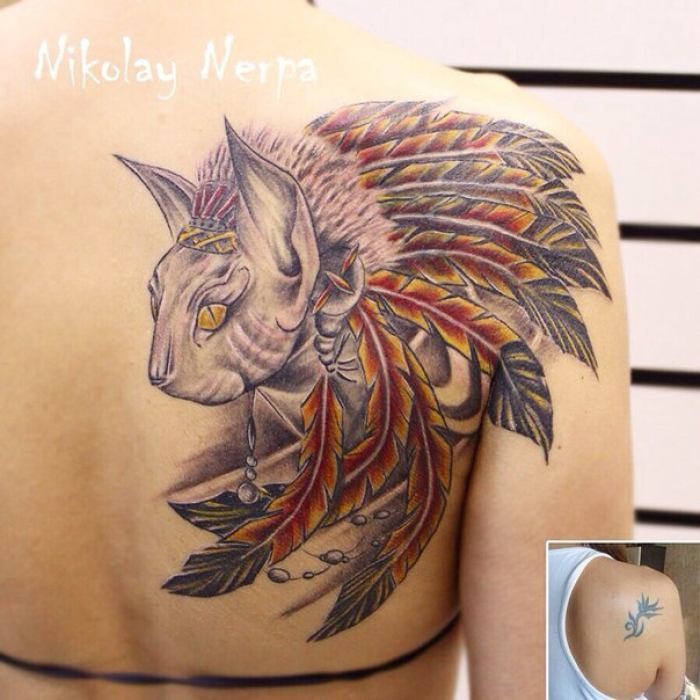 Indian native multicolored shoulder tattoo of tribal cat with feather helmet