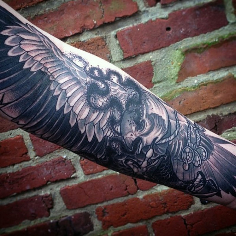 Indian style black and white eagle tattoo on forearm