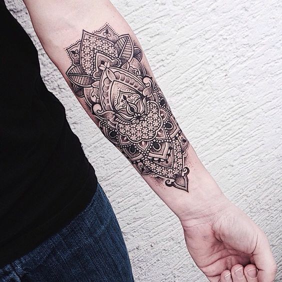 Indian style black and white floral tattoo on arm