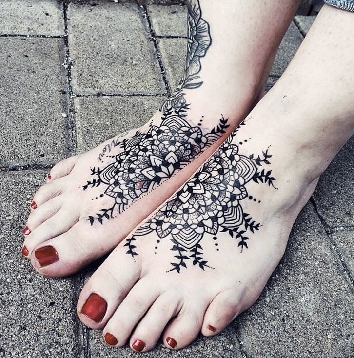 Interesting black and white separated flower tattoo on feet