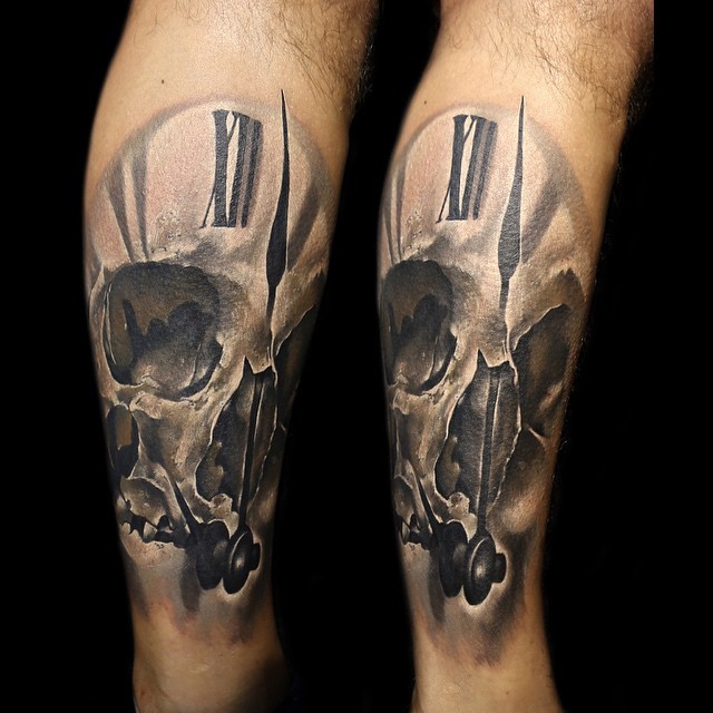 Interesting black ink clock tattoo stylized with human skull