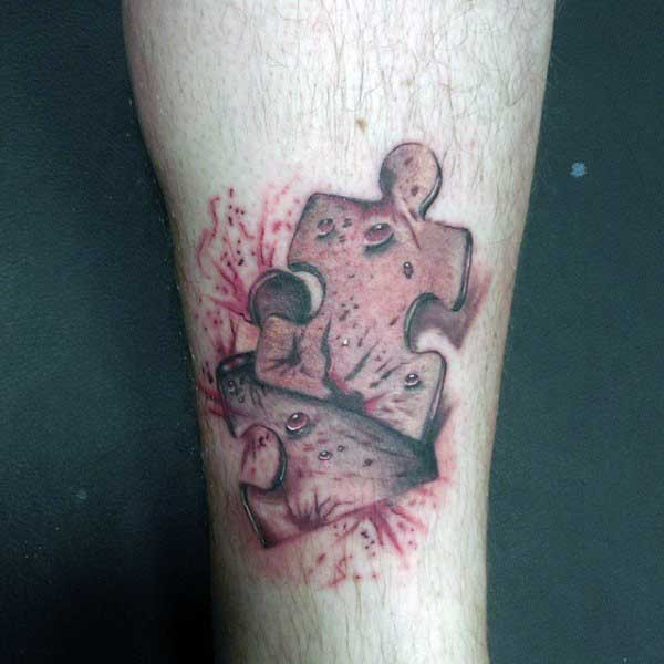 Interesting colored bloody leg tattoo of puzzle piece