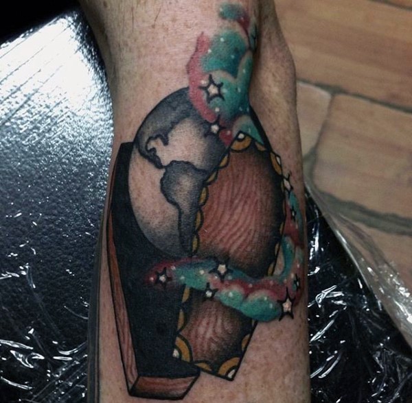 Interesting colored little coffin with planet and stars tattoo on arm