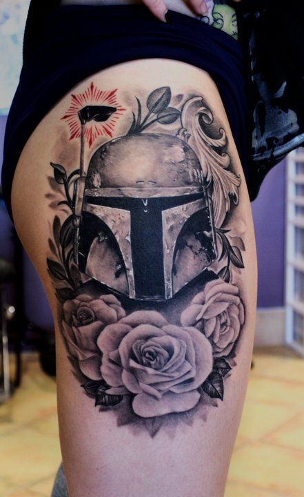 Interesting combined black ink Boba Fett portrait tattoo on thigh stylized with flowers