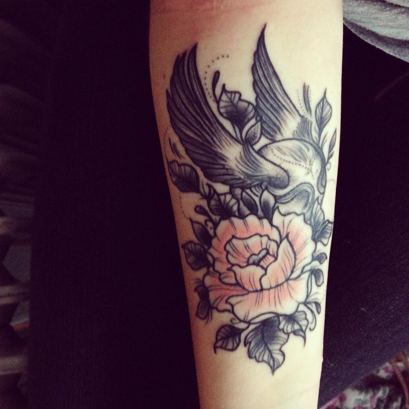 Interesting combined colored flowers tattoo on forearm with quidditch ball