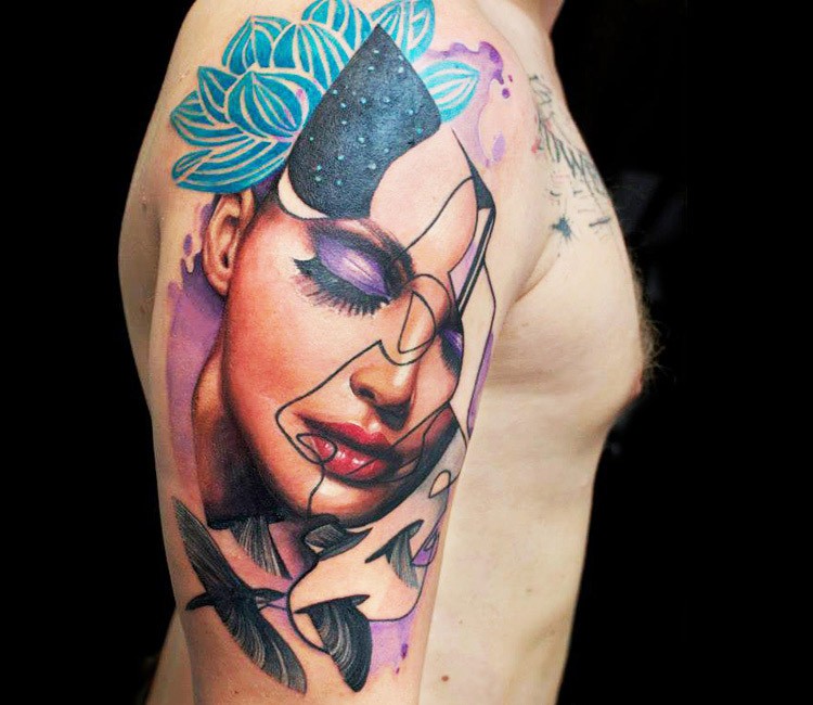Interesting combined realistic looking woman portrait tattoo on shoulder stylized with flowers and birds