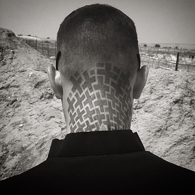 Interesting cross shaped geometrical tattoo on head and neck