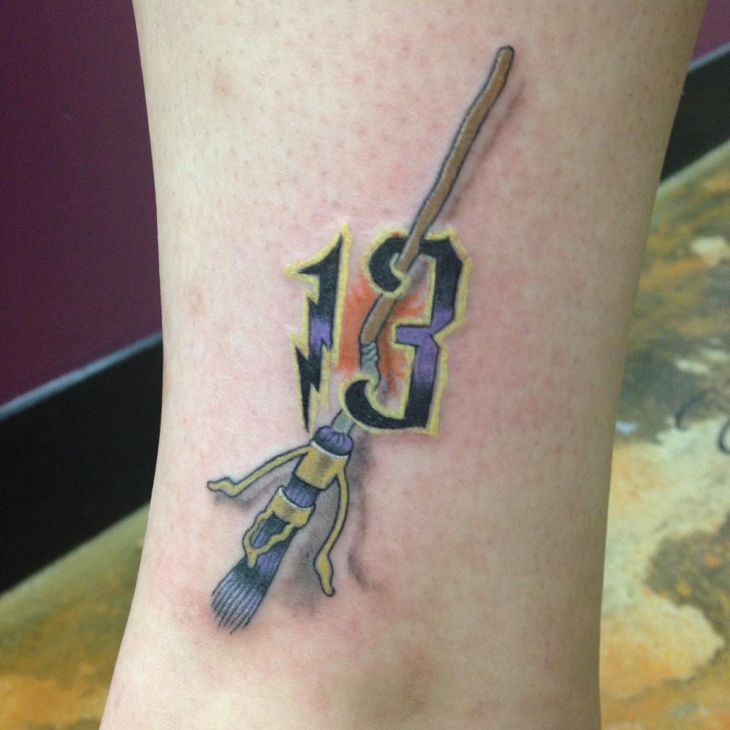 Interesting designed 3D style painted flying broom tattoo stylized with number