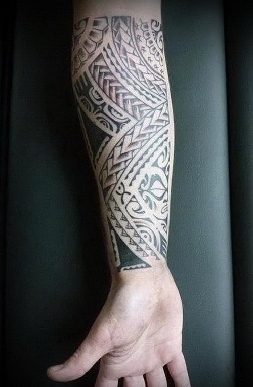 Interesting-designed tribal ornamented tattoo on forearm