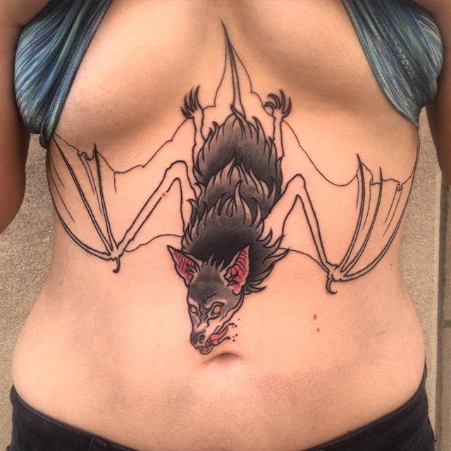 Interesting half colored bloody bat tattoo on belly