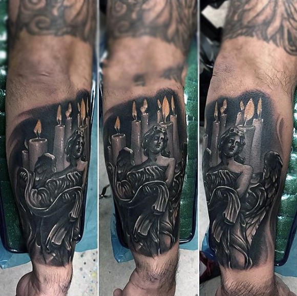 Interesting looking colored antic angel figure tattoo on forearm with burning candles