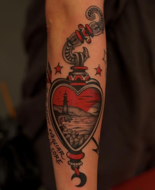 Interesting looking colored arm tattoo of human heart with lettering and lighthouse