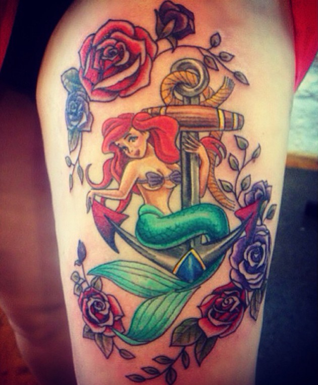 Interesting nautical themed colorful tattoo on thigh with cartoon mermaid and anchor